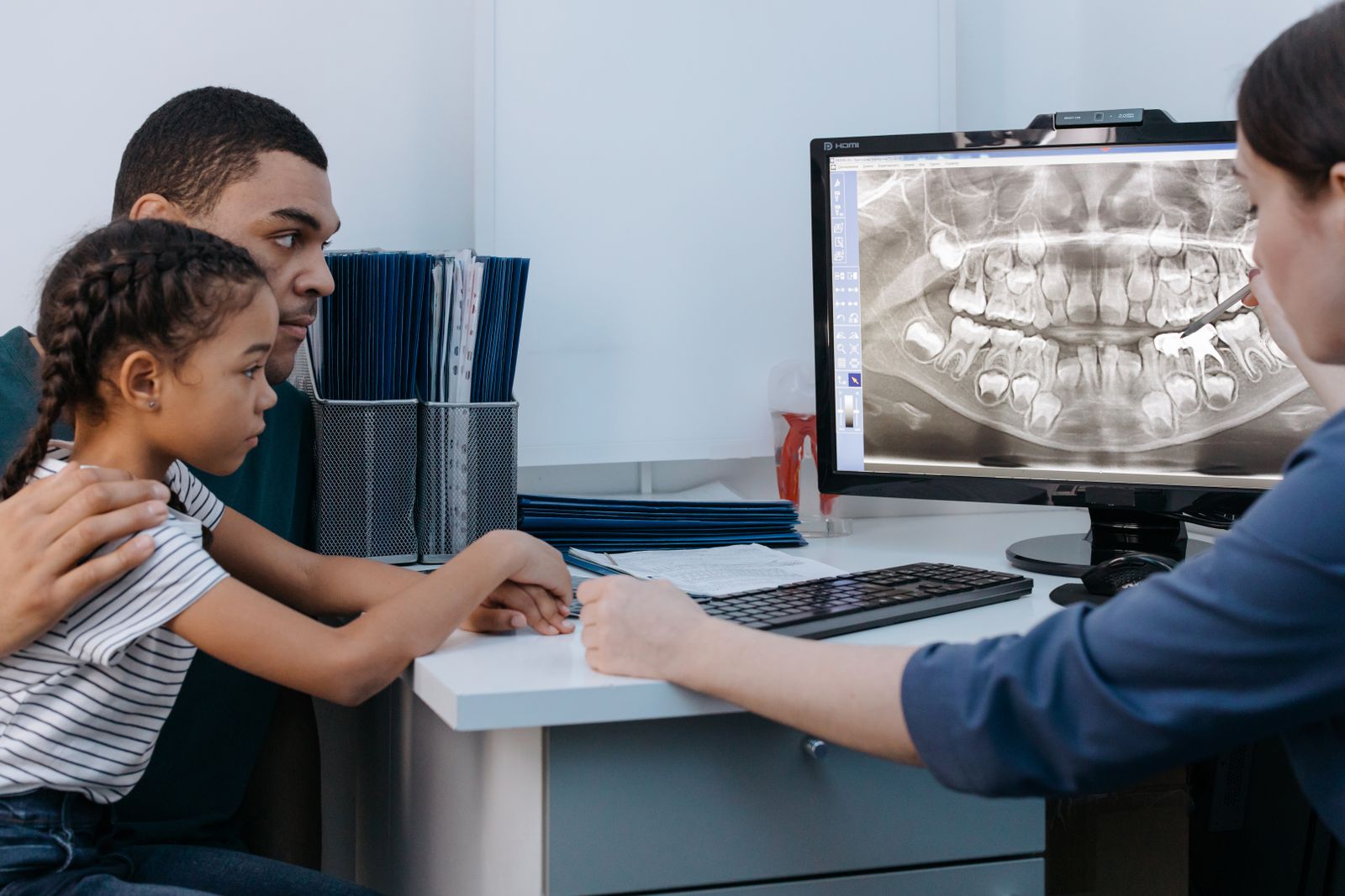 Parent and daughter reviewing a dental X-ray with a pediatric dentist in Christiansburg VA