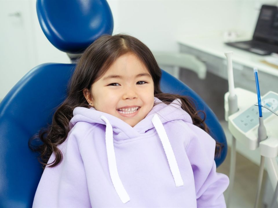 Smiling girl in a dental chair before getting dental sealants at our pediatric dentist office in Christiansburg, VA