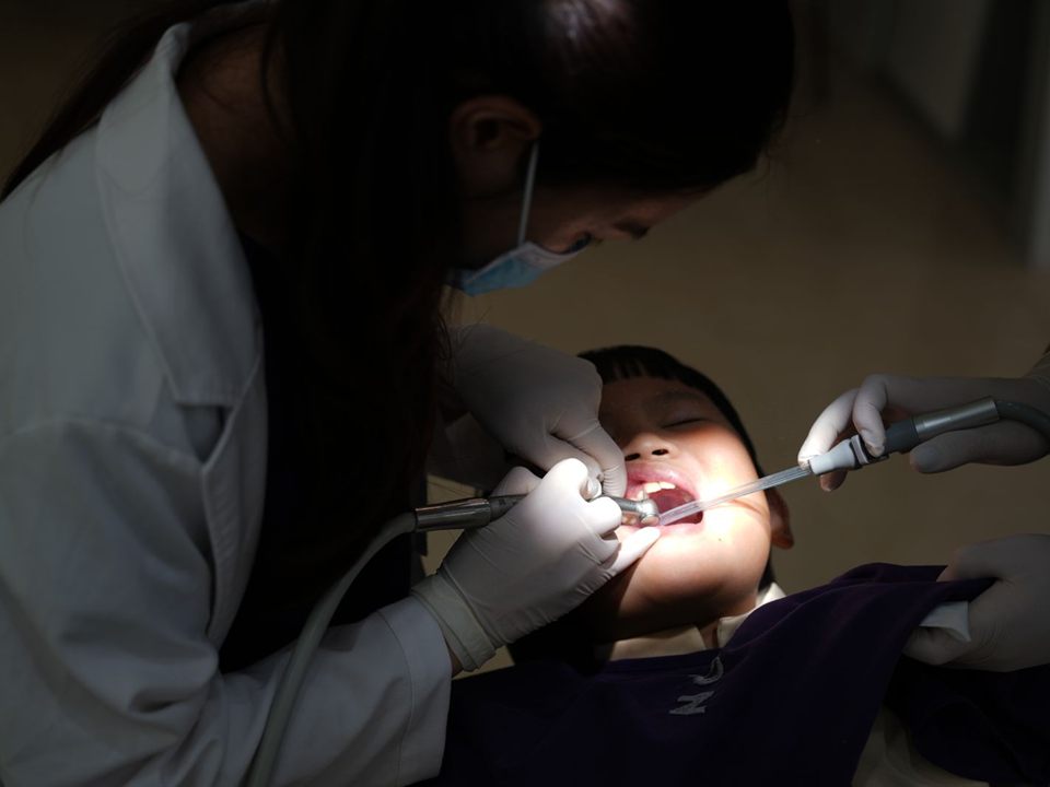 Dentist treating a child's tooth during pulp therapy at our pediatric dentist office in Christiansburg, VA