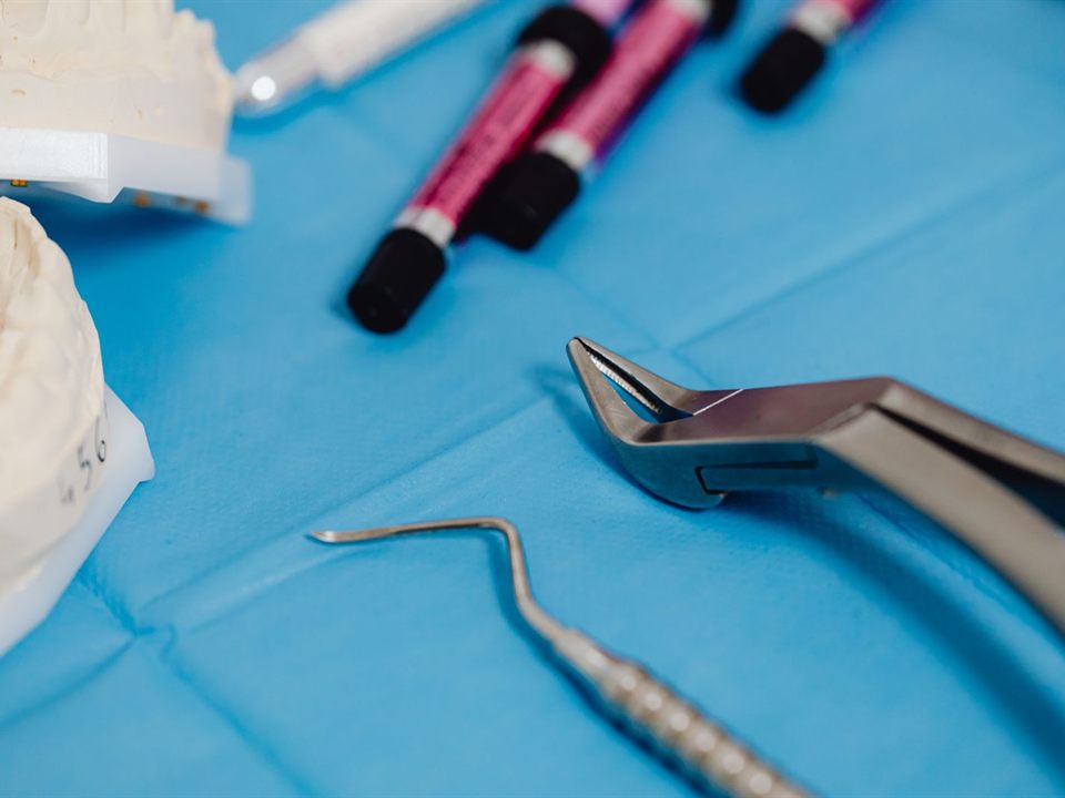 Dental instruments and a teeth model on a tray for a child's tooth extraction in Christiansburg, VA